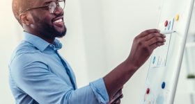 Radiant millennial employee preparing presentation in office