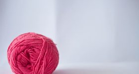 Ball of yarn in a white background