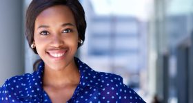 Happy business woman smiling outside office building