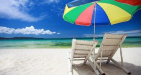 Two beach chairs and colorful umbrella